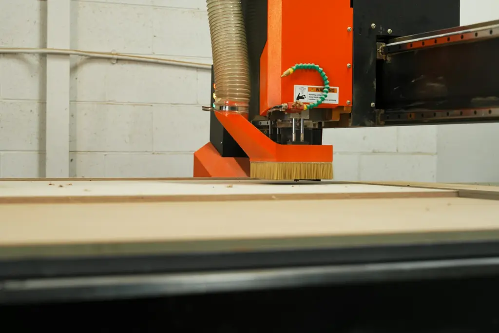 CNC router machine cutting a wooden board