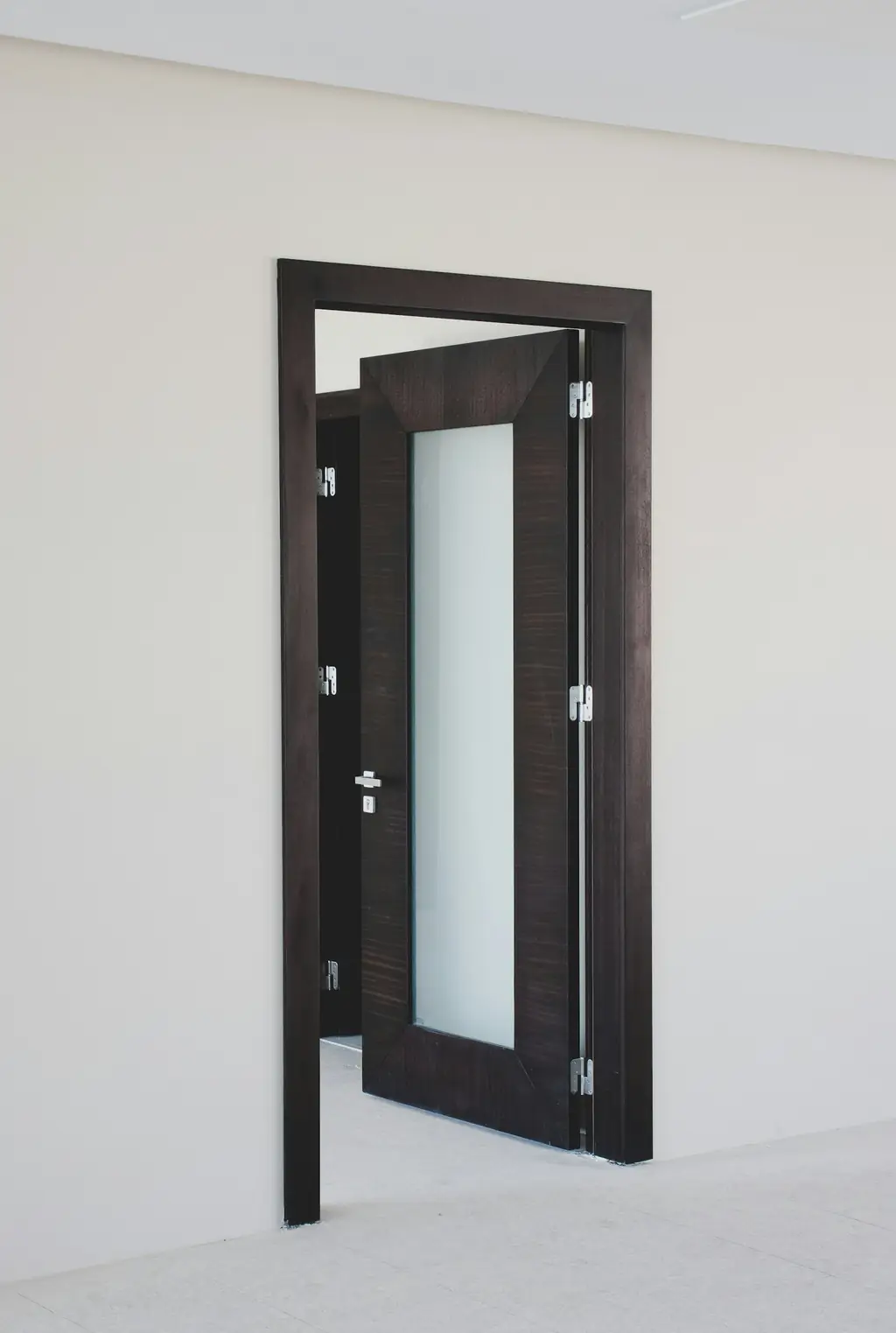 Dark wooden door with a glass strip panel