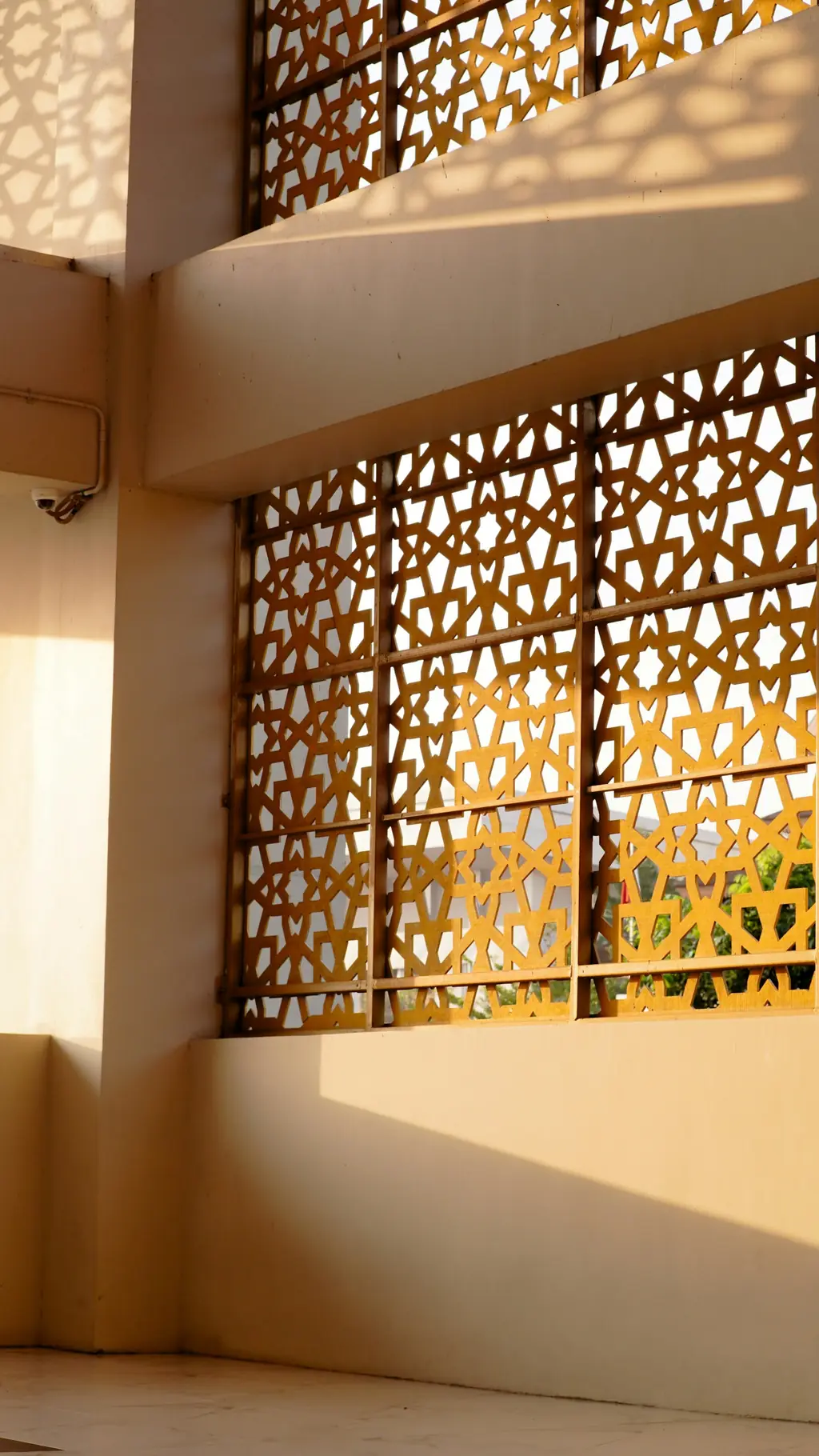 Jaali screen casting patterned light into a room