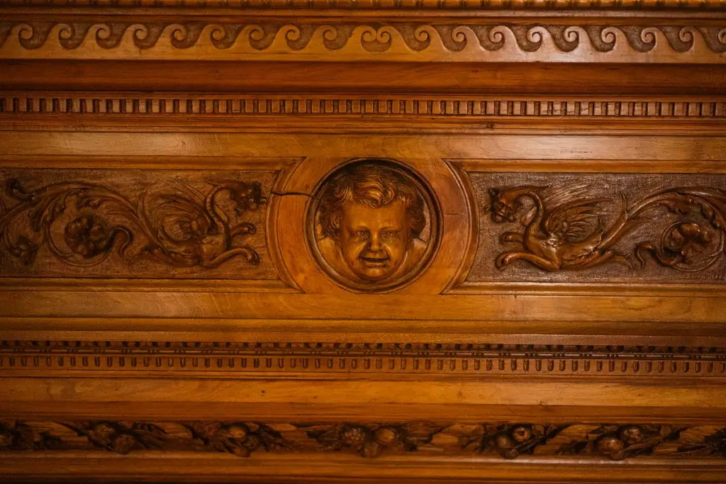 Wooden panel with carved relief and scrollwork