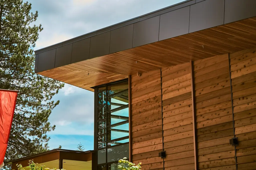 Wooden facade with a modern glass window