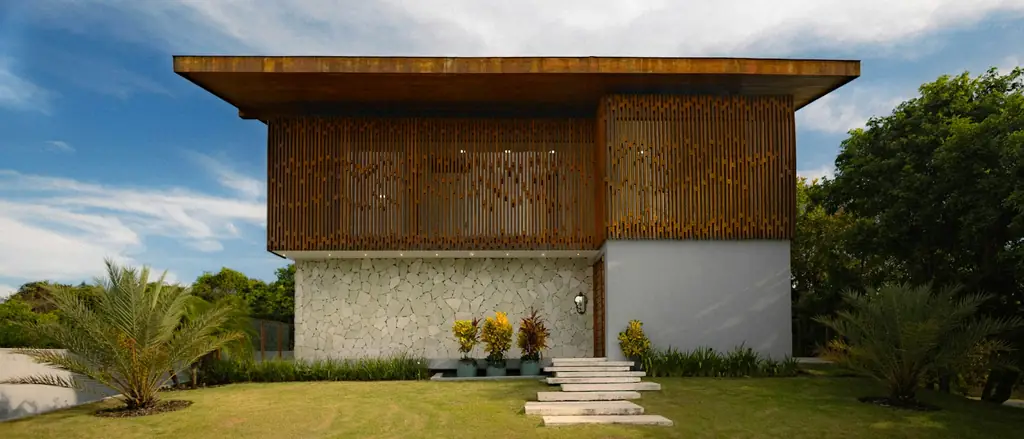 Modern house with wooden jaali screens over the windows