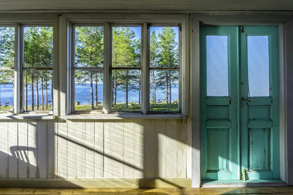 Large wooden window frames looking out to trees