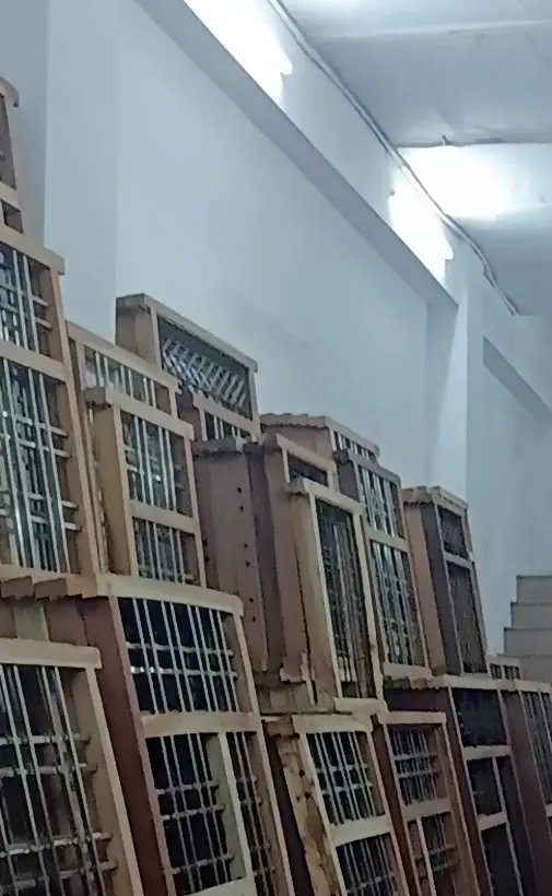 Row of ready wooden window frames with grills in our showroom