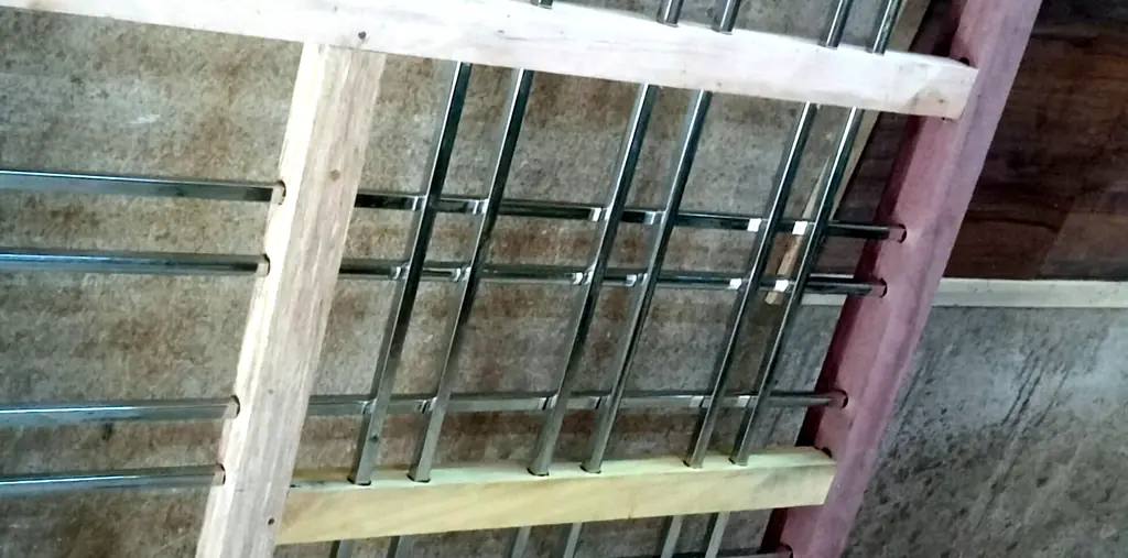 Wooden window frame with steel grill bars